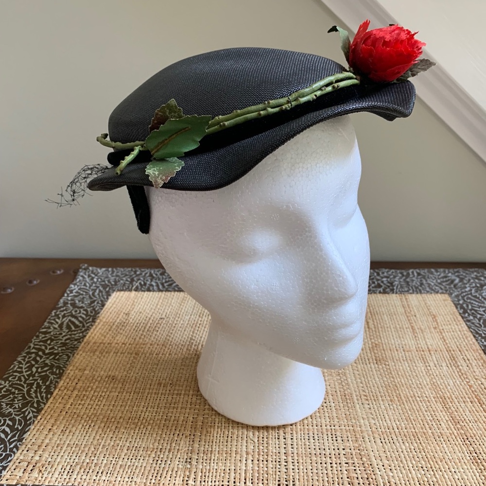 Vintage women’s woven black hat with red rose.